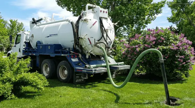 Professional vacuum truck performing residential drainage and septic maintenance in Bloomington, IN